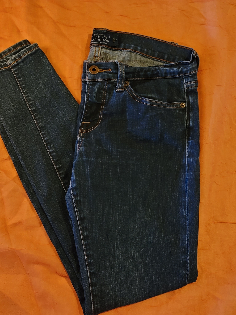Lucky Brand dark indigo jeans with gold hardware